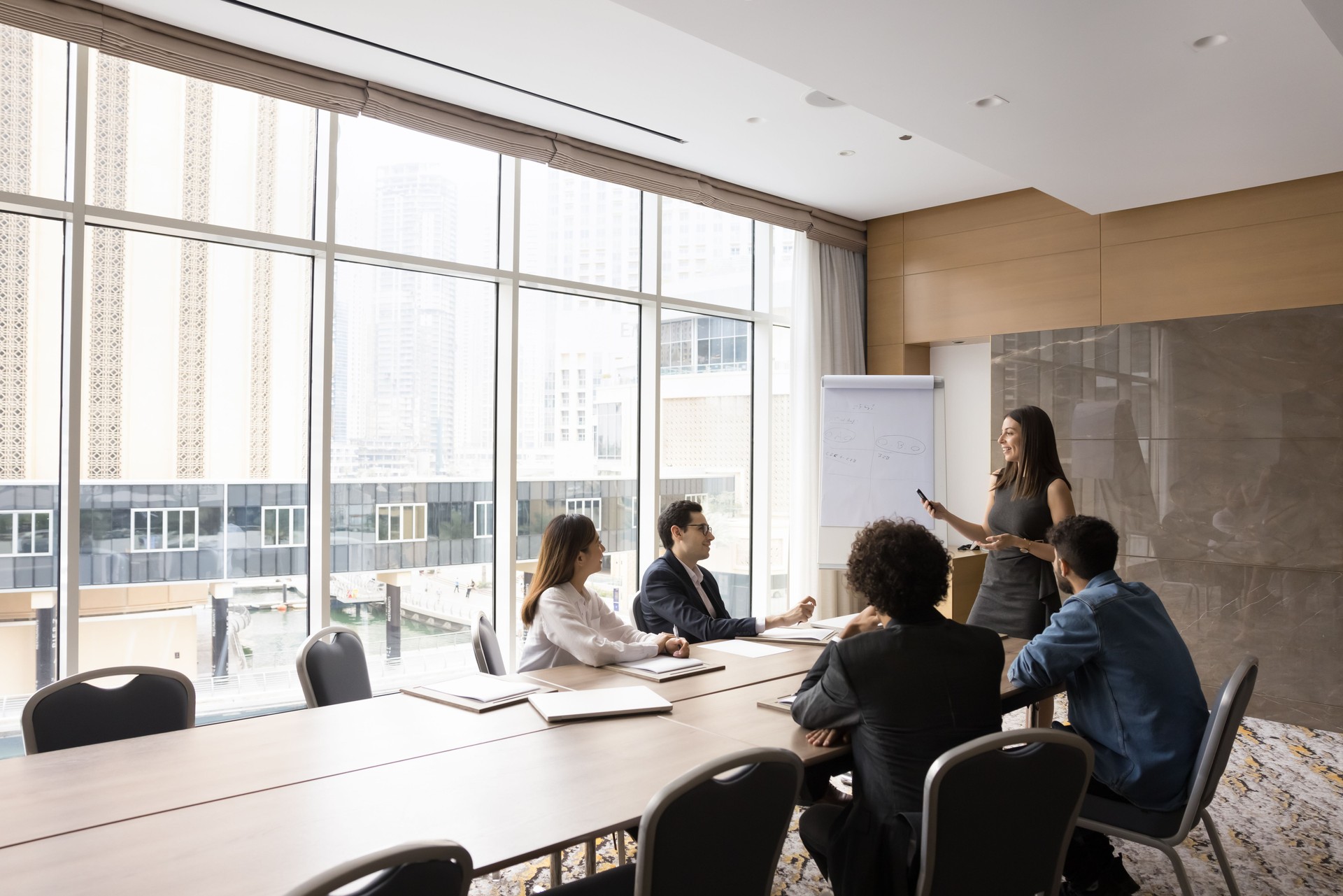 Skilled European female leader coaching interested business team